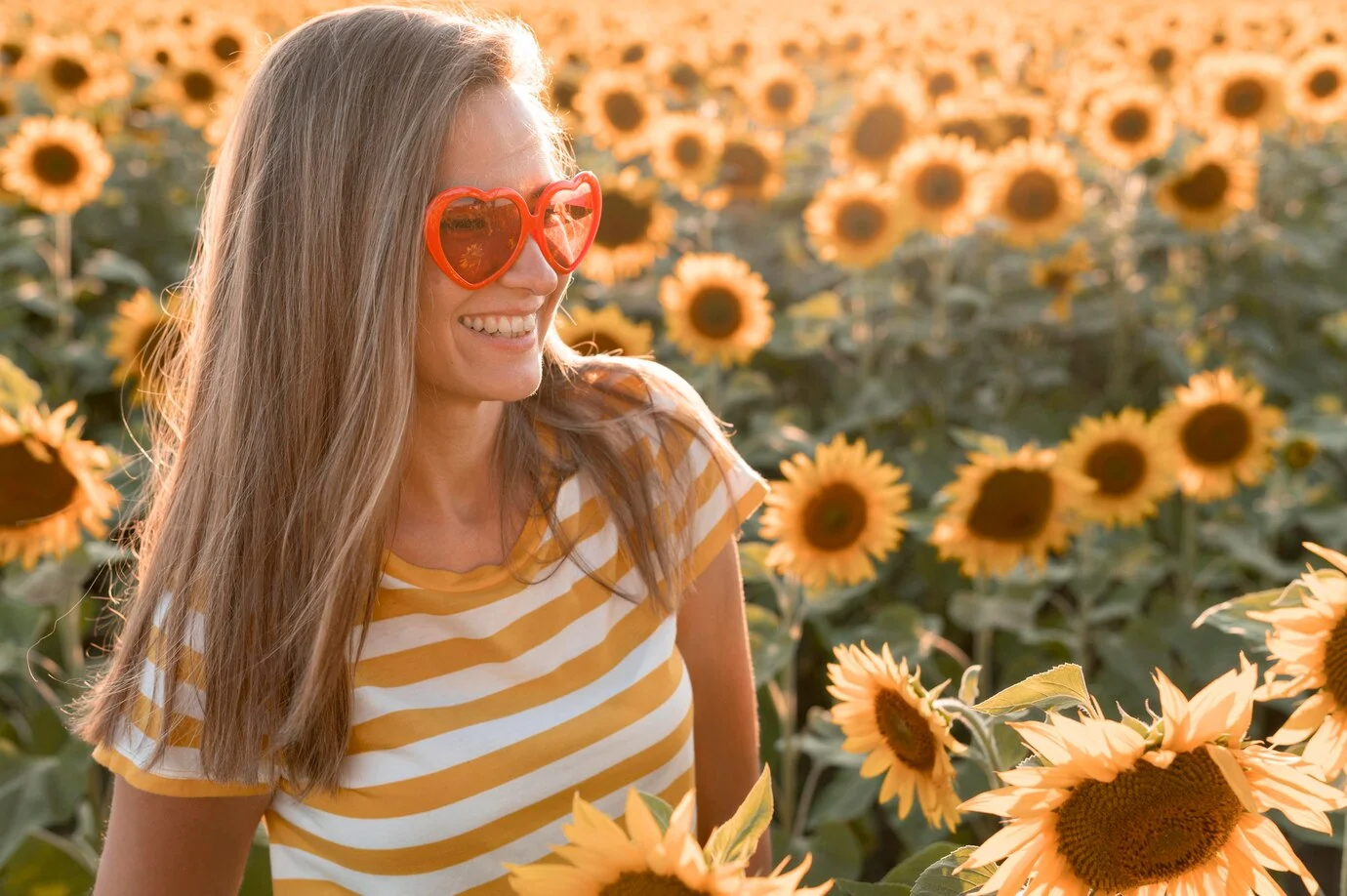 happy young woman in sunflower field